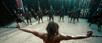 Movie still from “Ong Bak 3” (2010), directed by Tony Jaa – A group of men are in a circle with swords; Wide shot, Low angle