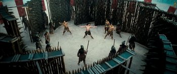 Movie still from “Ong Bak 3” (2010), directed by Tony Jaa – A group of men are playing a game in the sand; Extreme Wide shot, High angle