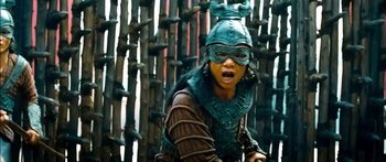 Movie still from “Ong Bak 3” (2010), directed by Tony Jaa – A person wearing a helmet and a mask; Medium shot, Low angle