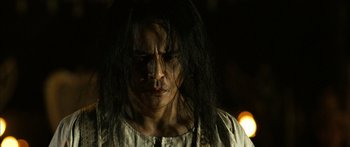 Movie still from “Ong Bak 3” (2010), directed by Tony Jaa – A person with long black hair; Close Up shot, Low angle