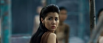 Movie still from “Ong Bak 3” (2010), directed by Tony Jaa – A person with long black hair; Close Up shot, Over the shoulder angle