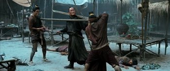 Movie still from “Ong Bak 3” (2010), directed by Tony Jaa – Two men are fighting in the middle of the street; Medium shot, Over the shoulder angle