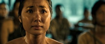 Movie still from “Ong Bak 3” (2010), directed by Tony Jaa – A woman's face with a blurry background; Close Up shot, Over the shoulder angle