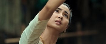 Movie still from “Ong Bak 3” (2010), directed by Tony Jaa – A person wearing a necklace; Close Up shot, Low angle