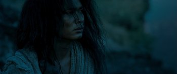 Movie still from “Ong Bak 3” (2010), directed by Tony Jaa – A woman with long black hair is looking to her left; Close Up shot, Low angle