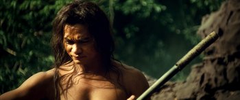 Movie still from “Ong Bak 3” (2010), directed by Tony Jaa – A man with long hair holding a spear; Close Up shot, Low angle