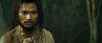 Movie still from “Ong Bak 3” (2010), directed by Tony Jaa – A person with long black hair; Close Up shot, Over the shoulder angle