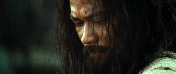 Movie still from “Ong Bak 3” (2010), directed by Tony Jaa – A person with long hair; Close Up shot, Low angle
