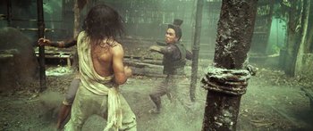 Movie still from “Ong Bak 3” (2010), directed by Tony Jaa – Two men are fighting in the rain; Medium shot, Over the shoulder angle