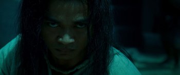 Movie still from “Ong Bak 3” (2010), directed by Tony Jaa – A person with long black hair; Close Up shot, Low angle