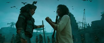 Movie still from “Ong Bak 3” (2010), directed by Tony Jaa – Two men are fighting in front of a group of people; Medium shot, Low angle