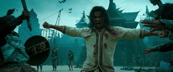 Movie still from “Ong Bak 3” (2010), directed by Tony Jaa – A man with blood all over his body and face; Medium shot, Low angle