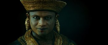 Movie still from “Ong Bak 3” (2010), directed by Tony Jaa – A person wearing a hat; Close Up shot, Low angle