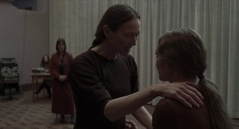 Movie still from “Suspiria” (2018), directed by Luca Guadagnino – Two women are talking to each other in a room; Medium shot, Over the shoulder angle