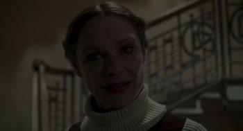 Movie still from “Suspiria” (2018), directed by Luca Guadagnino – A person wearing a sweater; Close Up shot, Low angle