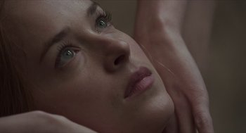 Movie still from “Suspiria” (2018), directed by Luca Guadagnino – A woman's face with green eyes; Extreme Close Up shot, Overhead angle