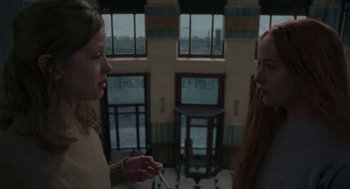 Movie still from “Suspiria” (2018), directed by Luca Guadagnino – Two women standing in front of each other in front of a building; Medium shot, Over the shoulder angle