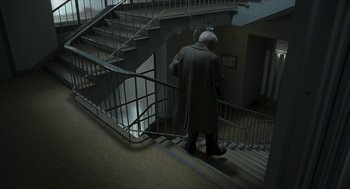 Movie still from “Suspiria” (2018), directed by Luca Guadagnino – An old man walking up a set of stairs; Wide shot, High angle