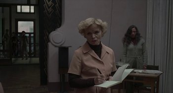 Movie still from “Suspiria” (2018), directed by Luca Guadagnino – An older woman is writing in a notebook; Medium shot, Over the shoulder angle