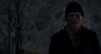 Movie still from “Suspiria” (2018), directed by Luca Guadagnino – An older man wearing glasses and a hat; Close Up shot, Over the shoulder angle