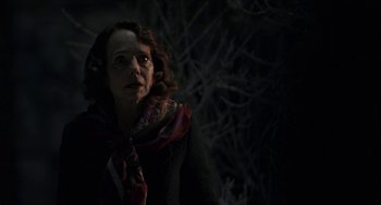 Movie still from “Suspiria” (2018), directed by Luca Guadagnino – A woman in a black jacket and a red scarf; Close Up shot, Over the shoulder angle