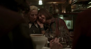 Movie still from “Suspiria” (2018), directed by Luca Guadagnino – Two women sitting at a table with a glass of red wine; Medium shot, Over the shoulder angle