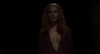Movie still from “Suspiria” (2018), directed by Luca Guadagnino – A woman with long red hair wearing a black dress; Medium shot, Low angle