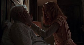 Movie still from “Suspiria” (2018), directed by Luca Guadagnino – An older man and a younger woman touching each other's face; Medium shot, Over the shoulder angle