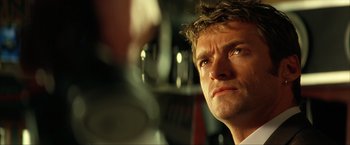 Movie still from “Swordfish” (2001), directed by Dominic Sena – A person looking at the camera; Close Up shot, Low angle