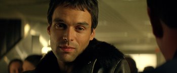 Movie still from “Swordfish” (2001), directed by Dominic Sena – A person wearing a leather jacket; Close Up shot, Low angle