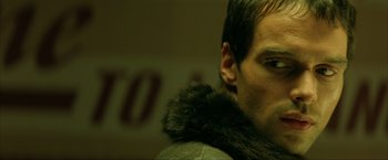 Movie still from “Swordfish” (2001), directed by Dominic Sena – A person wearing a jacket; Close Up shot, Low angle