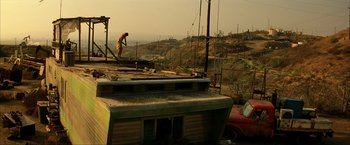 Movie still from “Swordfish” (2001), directed by Dominic Sena – A man standing on the roof of a building; Extreme Wide shot, Low angle