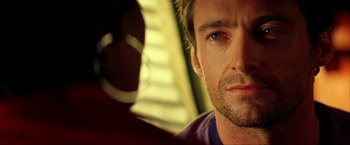 Movie still from “Swordfish” (2001), directed by Dominic Sena – A man's face in front of a window; Close Up shot, Over the shoulder angle