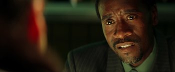 Movie still from “Swordfish” (2001), directed by Dominic Sena – A person wearing a suit and tie; Close Up shot, Over the shoulder angle