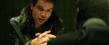 Movie still from “Swordfish” (2001), directed by Dominic Sena – A man talking to another man in a mirror; Close Up shot, Over the shoulder angle