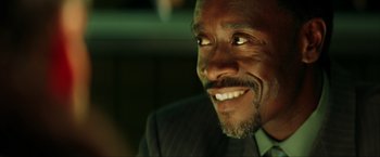 Movie still from “Swordfish” (2001), directed by Dominic Sena – A person wearing a suit and smiling; Close Up shot, High angle