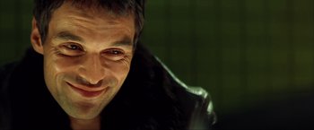 Movie still from “Swordfish” (2001), directed by Dominic Sena – A person wearing a leather jacket; Close Up shot, Low angle