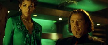 Movie still from “Swordfish” (2001), directed by Dominic Sena – A man and a woman are smoking in a room; Close Up shot, Low angle