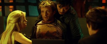 Movie still from “Swordfish” (2001), directed by Dominic Sena – A man sitting next to another man on top of a laptop computer; Medium shot, Over the shoulder angle