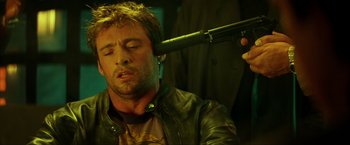 Movie still from “Swordfish” (2001), directed by Dominic Sena – A man with his head stuck in a hairbrush; Close Up shot, Over the shoulder angle