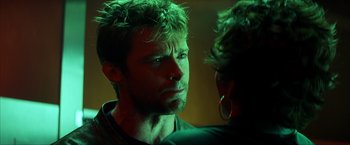 Movie still from “Swordfish” (2001), directed by Dominic Sena – A person looking at the camera; Close Up shot, Over the shoulder angle