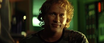 Movie still from “Swordfish” (2001), directed by Dominic Sena – A person with curly red hair; Close Up shot, Low angle