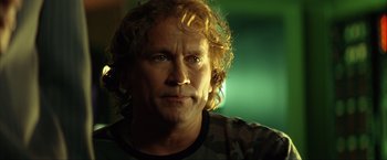 Movie still from “Swordfish” (2001), directed by Dominic Sena – A person with curly blonde hair; Close Up shot, Low angle