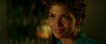 Movie still from “Swordfish” (2001), directed by Dominic Sena – A person with a smile on their face; Close Up shot, Over the shoulder angle
