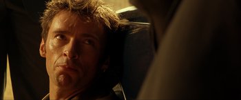 Movie still from “Swordfish” (2001), directed by Dominic Sena – A person wearing headphones; Close Up shot, Over the shoulder angle