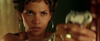 Movie still from “Swordfish” (2001), directed by Dominic Sena – A person holding a bottle of perfume; Close Up shot, Low angle