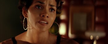 Movie still from “Swordfish” (2001), directed by Dominic Sena – A woman's face as she stares into the camera; Close Up shot, High angle