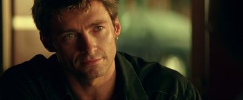 Movie still from “Swordfish” (2001), directed by Dominic Sena – A person wearing a black shirt; Close Up shot, Over the shoulder angle