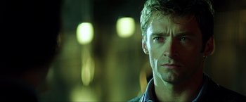 Movie still from “Swordfish” (2001), directed by Dominic Sena – A man's face in the dark; Close Up shot, Low angle