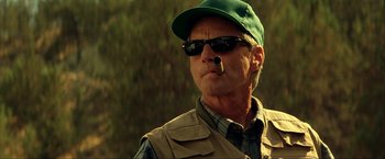 Movie still from “Swordfish” (2001), directed by Dominic Sena – A person wearing sunglasses and a hat; Close Up shot, Low angle